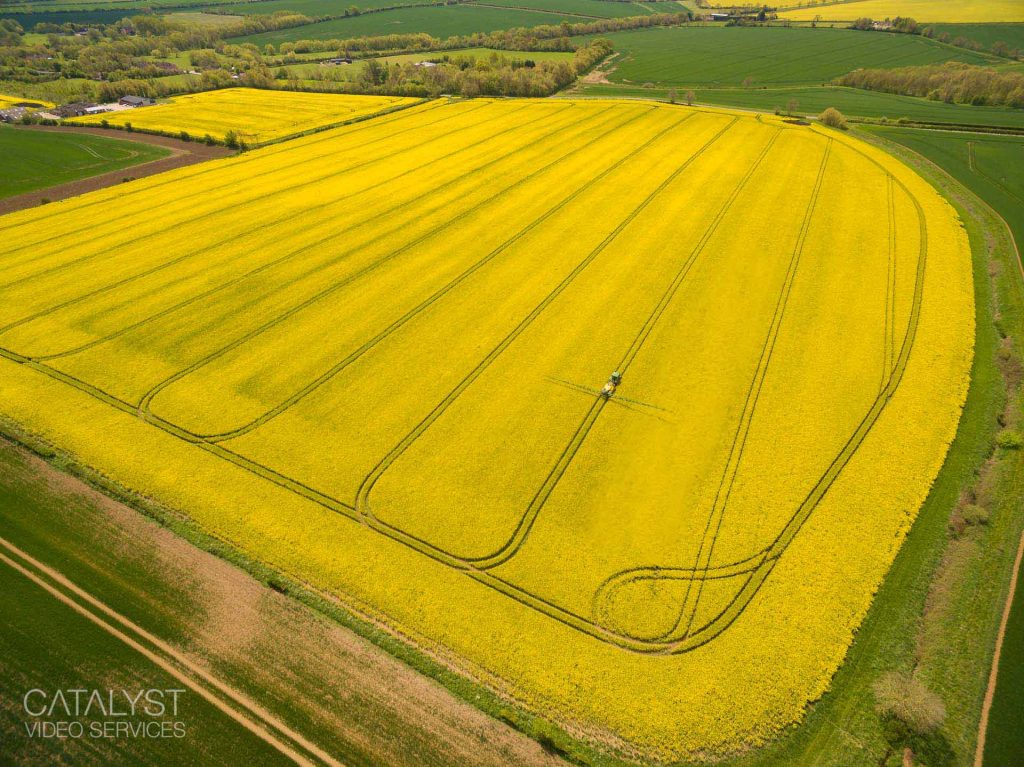 Aerial photograph of oil seed rape fields being sprayed